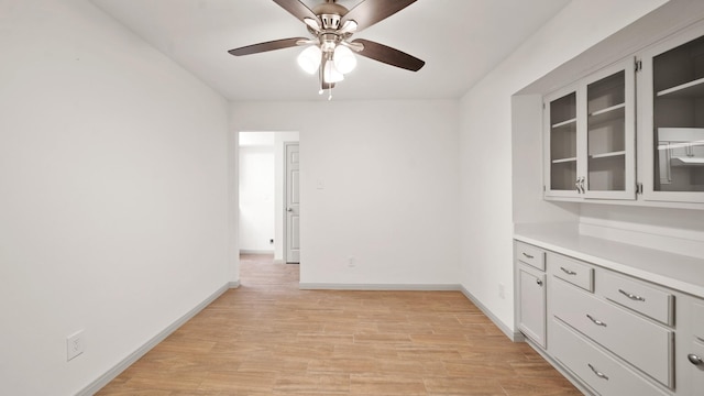 spare room featuring ceiling fan and light hardwood / wood-style flooring