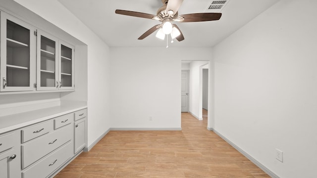 unfurnished dining area with ceiling fan and light hardwood / wood-style flooring