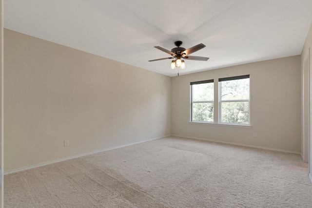 empty room featuring light colored carpet and ceiling fan