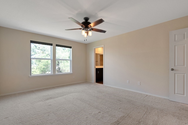 carpeted empty room featuring ceiling fan