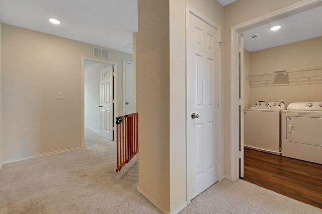 hall featuring light hardwood / wood-style floors and washing machine and dryer