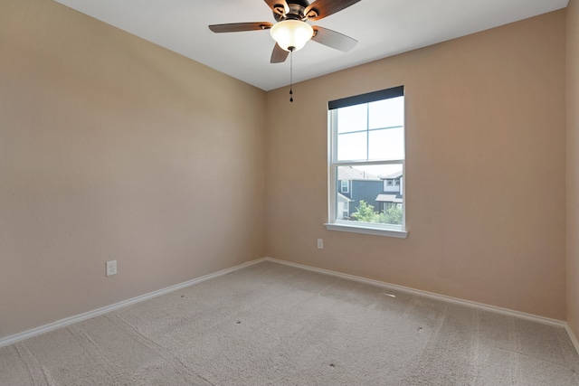 carpeted spare room featuring ceiling fan