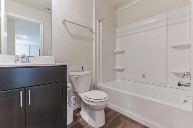 full bathroom with toilet, hardwood / wood-style floors, vanity, and shower / bathtub combination