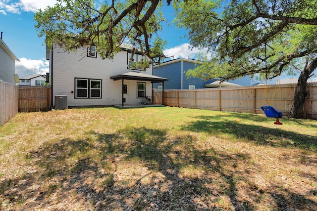 rear view of house featuring a yard and cooling unit