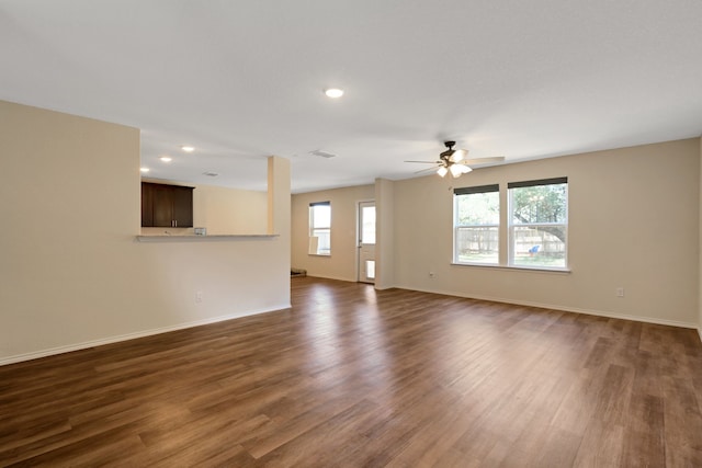 unfurnished living room with dark hardwood / wood-style floors and ceiling fan