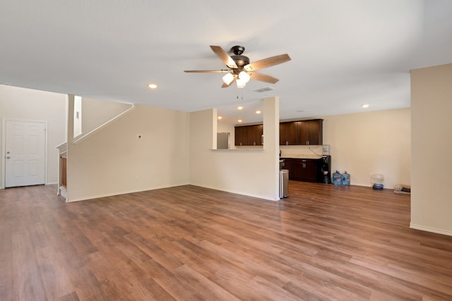 unfurnished living room with ceiling fan and hardwood / wood-style flooring