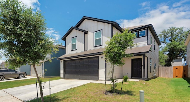 view of front of home with a front lawn and a garage