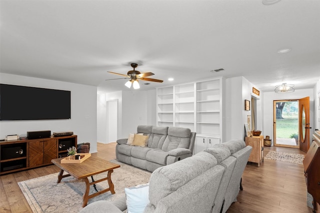 living room featuring light wood-type flooring and ceiling fan