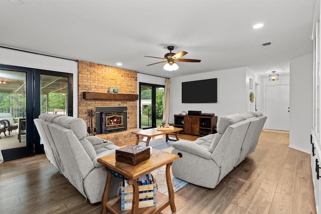 living room featuring hardwood / wood-style flooring and ceiling fan