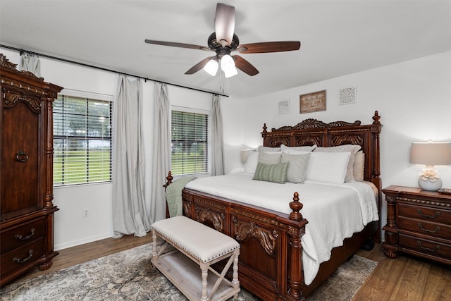 bedroom featuring multiple windows, ceiling fan, and dark wood-type flooring