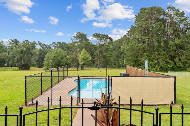 view of swimming pool with a lawn