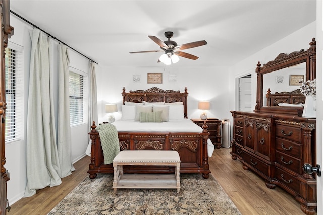 bedroom with light hardwood / wood-style floors and ceiling fan