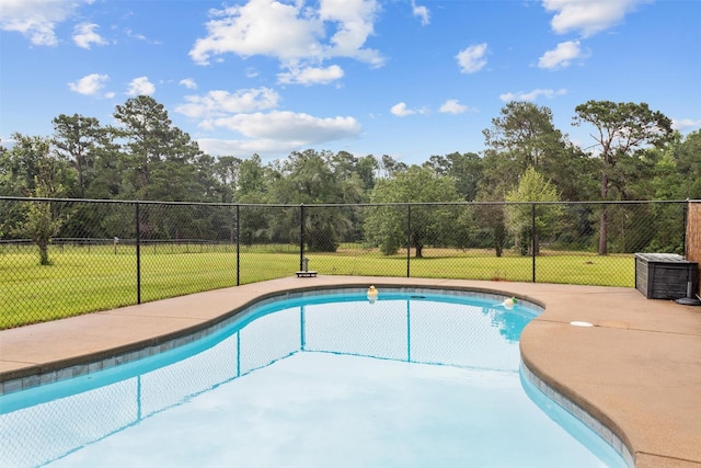 view of swimming pool featuring a lawn and a patio