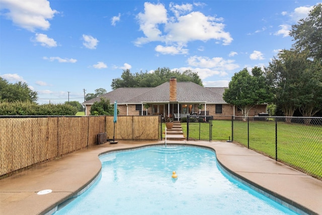 view of pool featuring a lawn