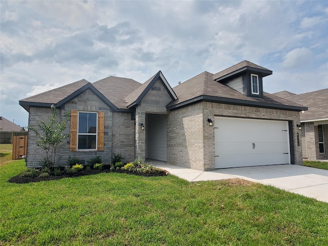 view of front facade with driveway, a garage, a front yard, and brick siding