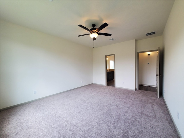 unfurnished bedroom with carpet, visible vents, baseboards, and ensuite bathroom