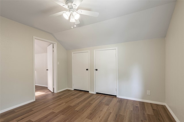 unfurnished bedroom featuring hardwood / wood-style flooring, ceiling fan, and vaulted ceiling