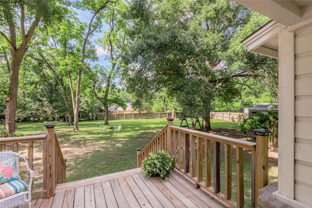 wooden deck featuring a lawn