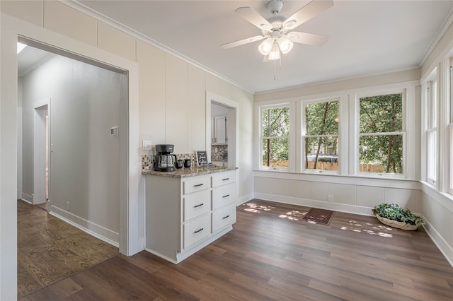 interior space with dark wood-type flooring, plenty of natural light, and ceiling fan