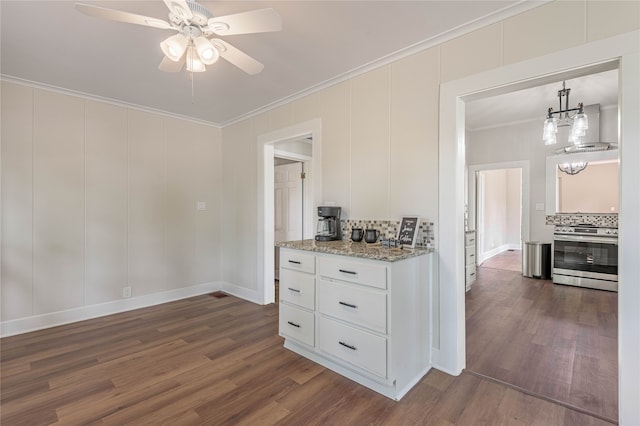 kitchen with stainless steel stove, white cabinets, ceiling fan, and dark hardwood / wood-style floors