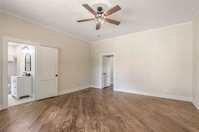 empty room featuring sink, ceiling fan, ornamental molding, and wood-type flooring