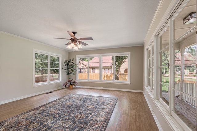 sunroom with ceiling fan