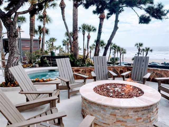 view of patio featuring a water view and an outdoor fire pit