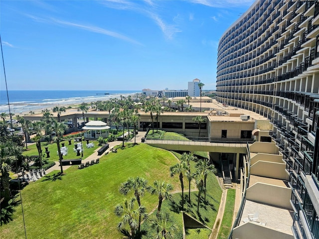 birds eye view of property with a water view and a view of the beach