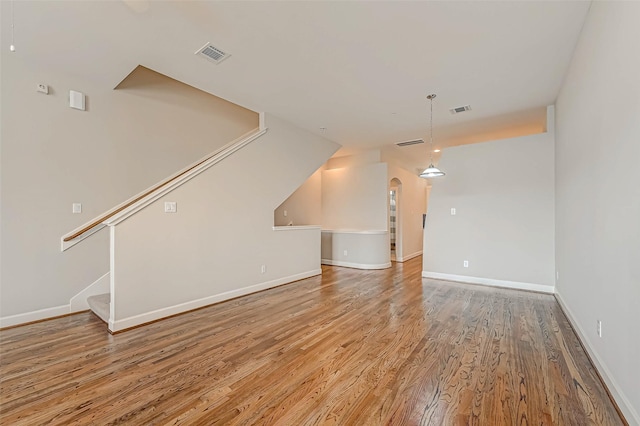 unfurnished living room with hardwood / wood-style floors