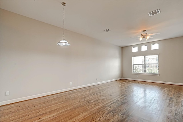 unfurnished room with ceiling fan and hardwood / wood-style floors