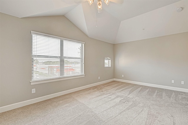 empty room featuring light carpet, ceiling fan, and lofted ceiling