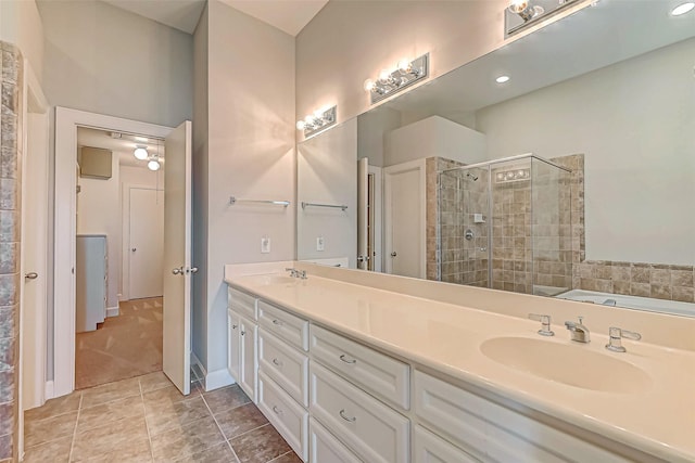 bathroom featuring vanity, tile patterned floors, and a shower with shower door