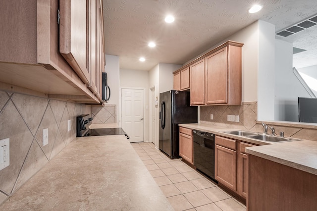 kitchen featuring sink, a textured ceiling, decorative backsplash, light tile patterned flooring, and black appliances