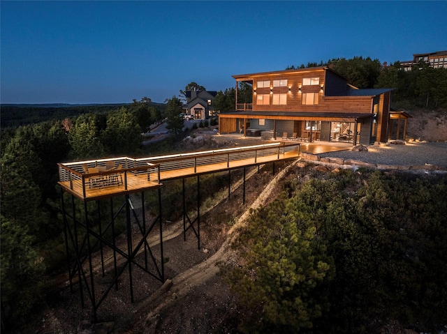 back house at dusk with a patio area