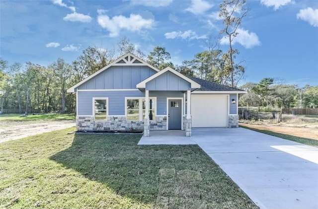 view of front facade with a front yard, a porch, and a garage