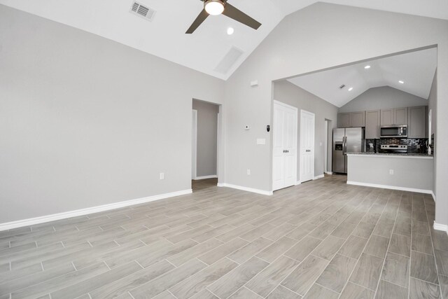 unfurnished living room featuring light hardwood / wood-style floors, high vaulted ceiling, and ceiling fan