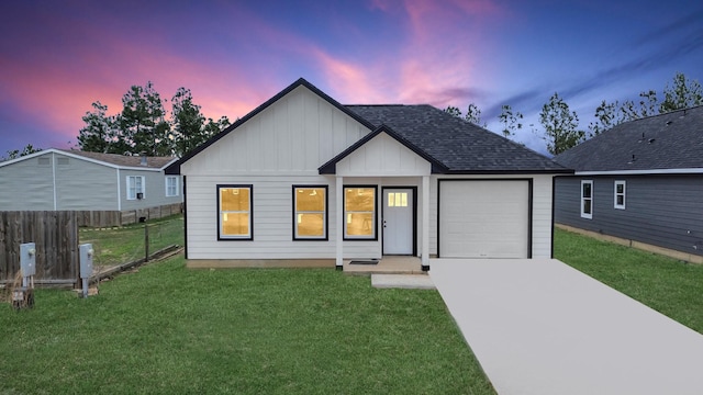 view of front of home featuring a garage and a lawn