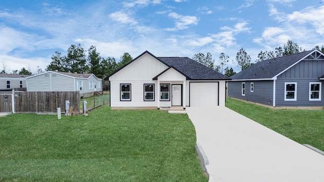 view of front of home with a garage and a front yard