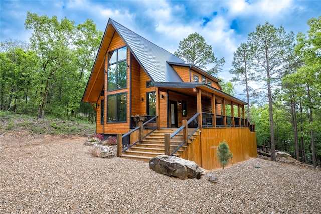 chalet / cabin featuring stairs and metal roof