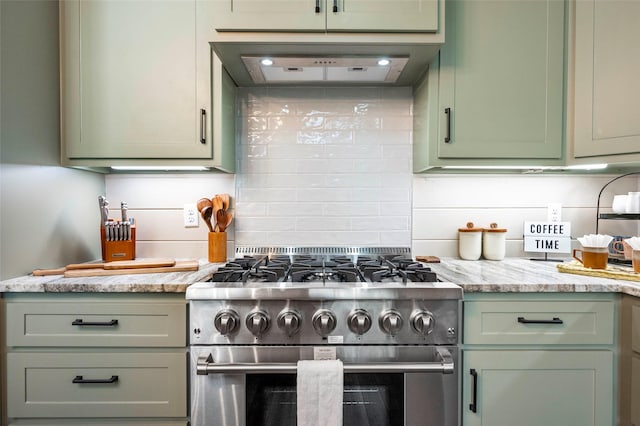 kitchen featuring backsplash, stainless steel range, extractor fan, and green cabinetry