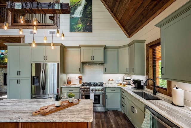 kitchen with stainless steel appliances, green cabinetry, a sink, and visible vents