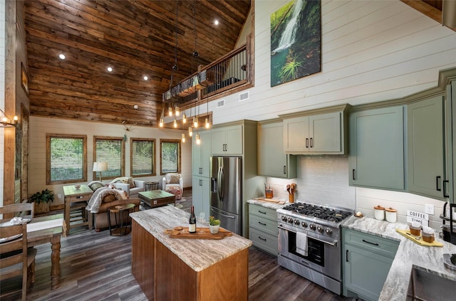 kitchen featuring high vaulted ceiling, light stone counters, wood walls, wood ceiling, and appliances with stainless steel finishes