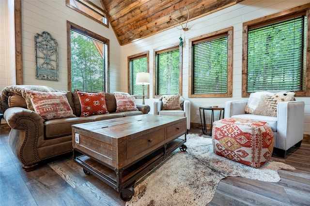 living area featuring high vaulted ceiling, wood walls, and hardwood / wood-style floors