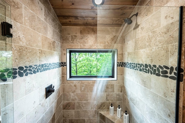 bathroom with wooden ceiling and tiled shower