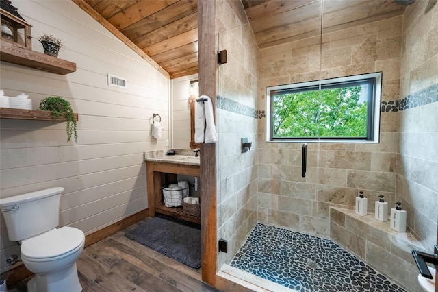 bathroom with visible vents, a stall shower, vaulted ceiling, wood finished floors, and wooden ceiling