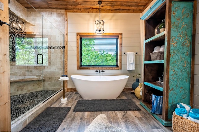 full bath with wooden ceiling, a soaking tub, a shower stall, and wood finished floors