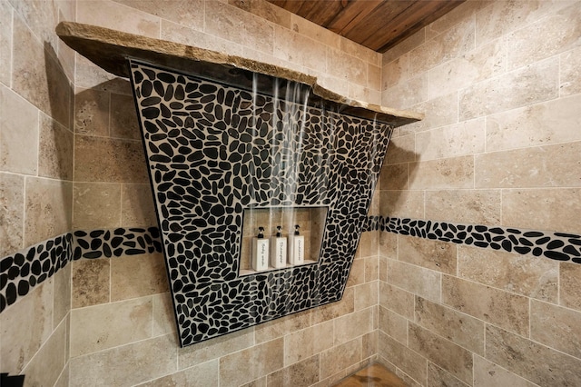 interior details featuring tiled shower