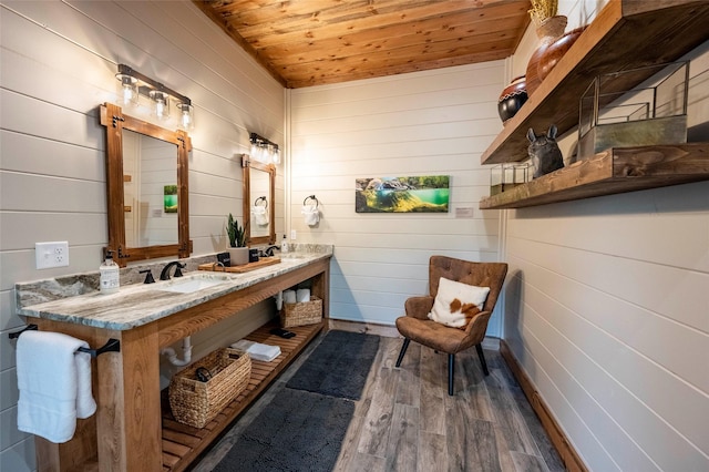 full bathroom featuring wooden ceiling, double vanity, a sink, and wood finished floors