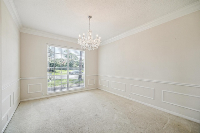 carpeted empty room featuring crown molding, a textured ceiling, and a notable chandelier