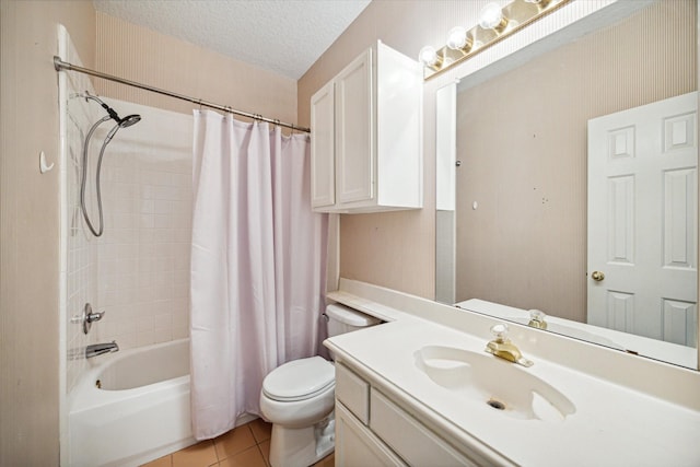 full bathroom with tile patterned floors, vanity, a textured ceiling, shower / bath combo with shower curtain, and toilet